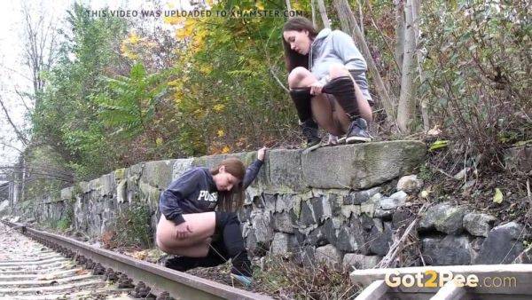 Watch these kinky girls get soaked in pee while getting frisky on the railway - sexu.com on v0d.com