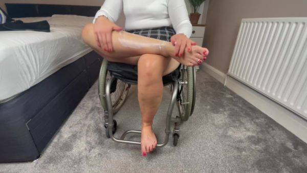 Wheelchair Girl Massaging Legs And Feet After Work - hclips.com on v0d.com