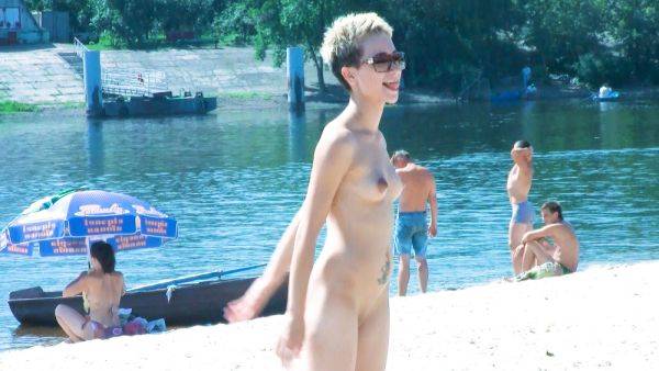 Nude beach girl chats with her friends lays naked and enjoys the sun - hclips.com on v0d.com