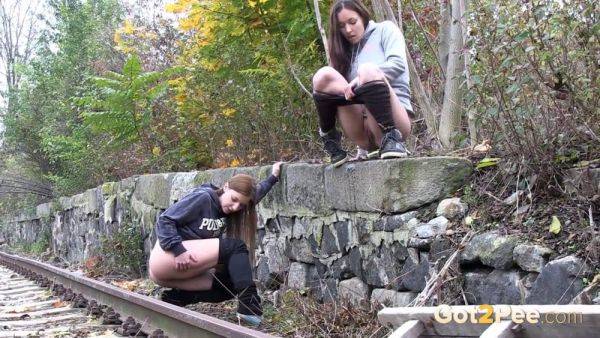 Brunette girls get desperate for a public pee session in the railway - sexu.com - Czech Republic on v0d.com